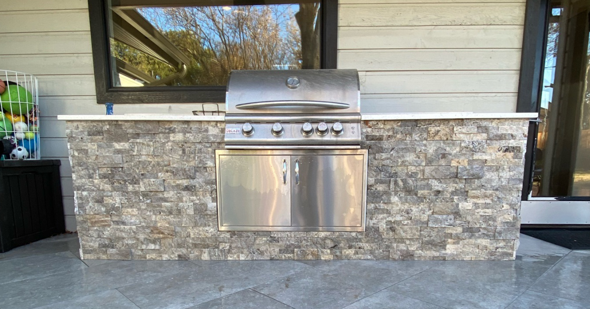 Picture of outdoor kitchen complete with built-in gas grill.