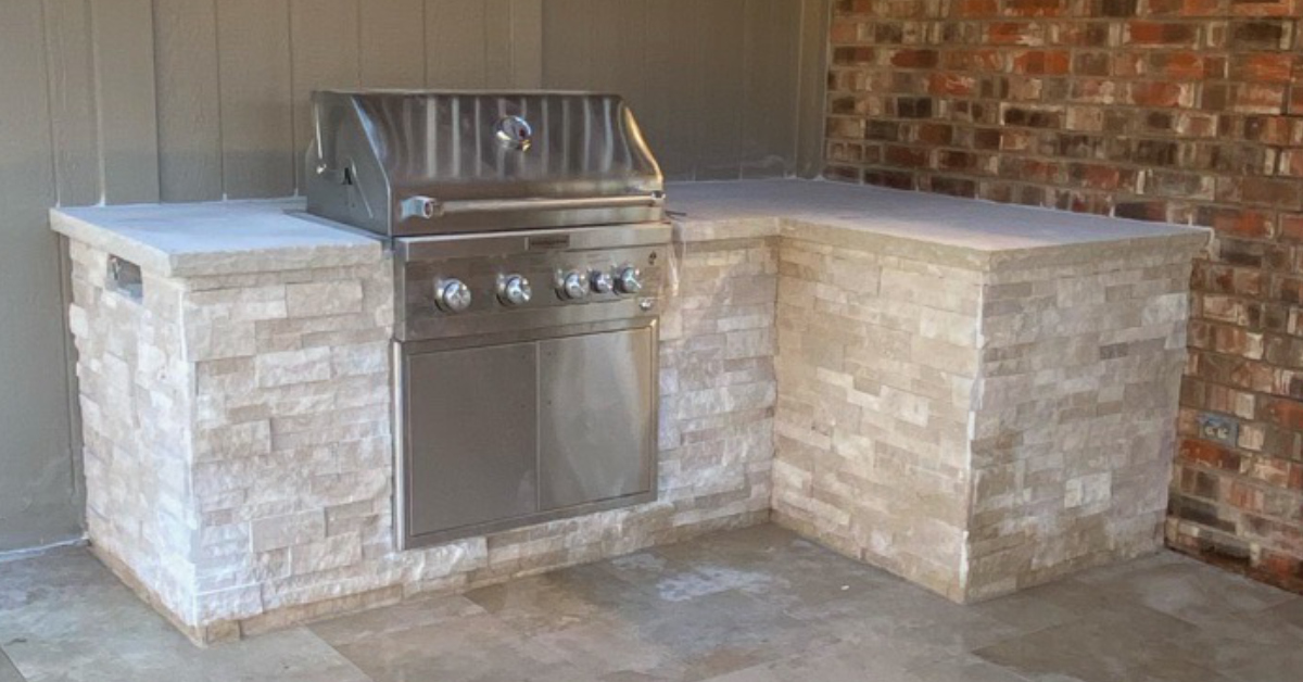 Picture of outdoor kitchen complete with built-in gas grill.
